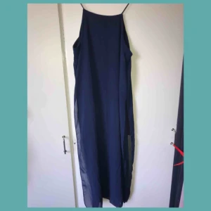  - Elegant och simpel klänning till sommaren, materialet är i chiffong vilket passar perfekt till varmt väder, klänningen har två slits på varsin sida. 