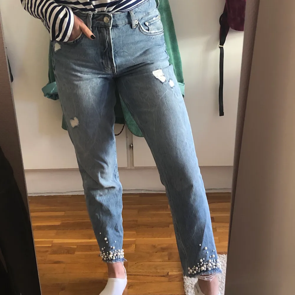 Ljusblåa mom-jeans från H&M med pärlor längst ner och slitningar! Medium höga och storlek 27 i midja. Passar mig bra i längd som är 161 lång. Nästan aldrig använda bara 2-3 gånger. Jeans & Byxor.