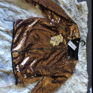  - En paljettjacka i färgen guld/rosé guld & Silver. Köptes till nyår 2017/2018, kom aldrig till användning för inte redigt min stil. Har bara provat den. Köpte denna på New Yorker för 400, säljes då för 300 +frakt