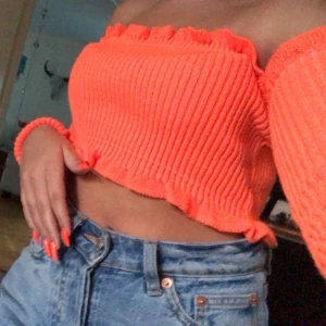 Neon orange off shoulder topp - Från madlady. Knappt använd så nyskick. Storlek XS men passar även S och M, eftersom den är väldigt stretchig 