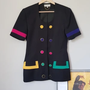 VINTAGE 80s kavaj - BALLASTE KAVAJEN I STAN!? Helt fantastisk unik kavaj med kort ärm från åttiotalet. Är lite ledsen över att behöva sälja den men den passar mig inte längre. Står att det är storlek 12 på tagen, skulle säga att den passar som storlek 36/38 beroende på hur man vill att den ska sitta. Köpare står för frakt, tippar på ca 60kr <3 
