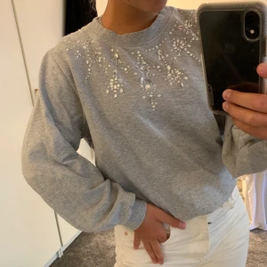 Grå sweatshirt - Jättefin tröja med fin detalj runt halspartiet! Alla ”pärlor” sitte kvar, nån enstaka som sitter lite löst! Storlek  XS, 75kr +frakt💗🌸
