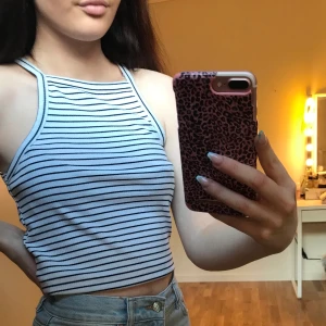 Randigt linne  - Ett svart, vitt randigt linne i storlek XS