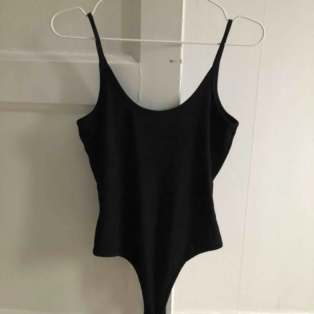 snygg basic svart bodysuit från Ivyrevel. Fin detalj med öppen rygg, perfekt inför sommaren☀️ Använd fåtal gånger. (OBS, pris inkluderar frakt) . Toppar.