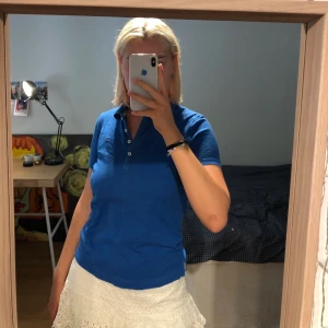 Piké Tommy Hilfiger - Klarblå pikétröja från Tommy Hilfiger, modellen classic fit i storlek xs