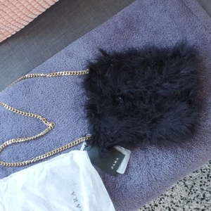 Zara clutch  - Zara clutch unused, material: feathers in black with gold chain strap. Also has the dust bag size 20cm H 16cmW