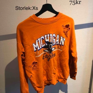  - Orange tröja med revor/hål.