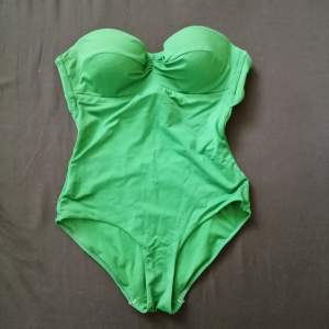 Green swim suit size S from previous years. Worn for one summer. In good condition. Stripe is lost. 