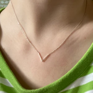 Superfint silvrigt halsband!  - Jättefint silvrigt (ej äkta) halsband med ett litet triangelmotiv där fram. Justerbart (se bild två). 30 kr + frakt!