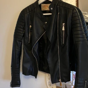 Skinnjacka  - Skinnjacka i FAKE skinn, jätte fin med silver detaljer inte använd så mycke då jag är rätt bredaxlade🖤 (Frakten står man för själv)