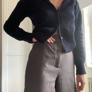 Grå kostymbyxor  - Säljer mina gråa kostymbyxor från Nakd. De är från kollektionen Monica Geuze x NA-KD. Byxorna är höga i midjan och sitter bra på. Säljer pga av att de inte kommer till användning. 🦋💓 skriv för fler bilder! Köparen står för frakten. 