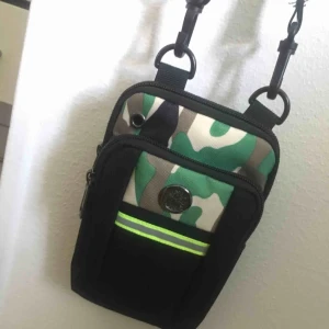  - Liten och behändig kamouflage väska, den typen av modell verkar ganska populär nu förtiden! Kommer tyvärr inte ihåg varifrån den är ifrån tyvärr! Men den är hel och fint än. Betalning sker via swish och köparen står för ev. Frakt!