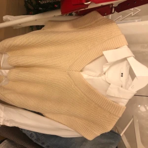 Beige/gräddvit väst  - Säljer nu min stickade väst då den inte kommer till användning längre. Den är från Gina i storlek S och är supersnygg att ha över ex skjorta! Bara använd några få gånger🥰