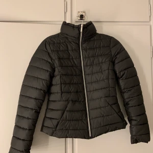 Dunjacka Zara - Dunjacka från zara, storlek S passformen är slim fit, jackan har en avtagbar luva med en dragkedja, den är som ny bara använd några gånger pågrund av att den blev för liten.