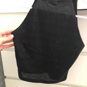 Glitter tröja  - En svart glittrig magtröja i storlek S, inga armar och en krage . Sömmen sitter fram men inget jag har tänkt på , 2 sista bilderna. Andvänd 3 gånger av mig men den är i bra skick 