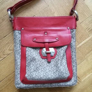  - Cross over från DKNY. Köpt i New york för några år sedan. De röda detaljerna är i skinn. Använd men jättefin!