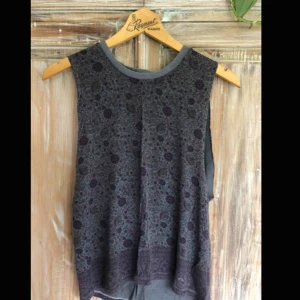  - American Eagle tröja utan ärmar. Står storlek XXS i men sitter löst, så passar minst upp till storlek S. Väldigt mjukt och skönt tyg, faller fint. Grå färg med blomdetaljer.