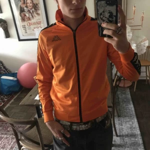  - Använd kappa track topp/tröja. Fint skick, har två lagade mikrohål på framsidan som knappt syns. Den saknar storleks lappen pga tvätt. Betalning genom swish eller cash vid meet up. Går att skicka men köparen står för frakt. Öppen till frågor samt bud!