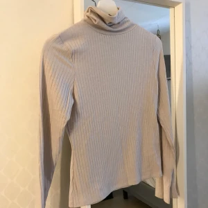 Ribbad polo tröja ljus ljus rosa - Långärmad polotröja ribbad från Nelly aldrig använd men lyckades ta av prislappen o kunde ej skicka tillbaka.