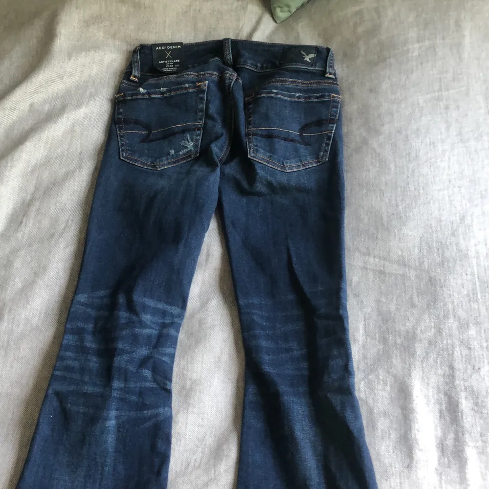 Mörkblåa slitna American Eagle jeans Flare och super stretch,  aldrig använda med lappen kvar!  . Jeans & Byxor.
