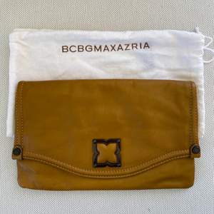 BCBG MaxAzria souple leather clutch bag. Magnetic closing, multiple pocket inside. Comes in original dust bag. Excellent condition, never used