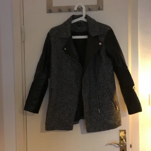  - En höst och vårjacka med tuffa skindetaljer. Jackan är använd men i gott skick. Den har två fickor med dragkedja. Jackan är köpt för ett par år sedan och kommer inte till användning längre.      Frakt ingår inte i priset. 