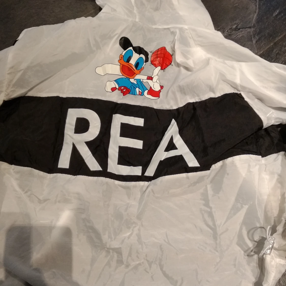 Genomskinlig jacka med Kalle anka på - 90