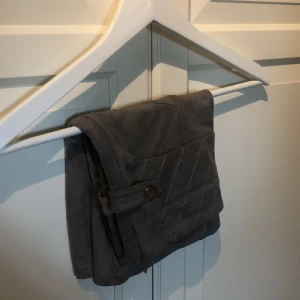 Sanne Alexandra kjol storlek xs - Grå/beige kjol från Sanne alexandra. Kjolen är i mocka material och har fina detaljer på sidorna. 