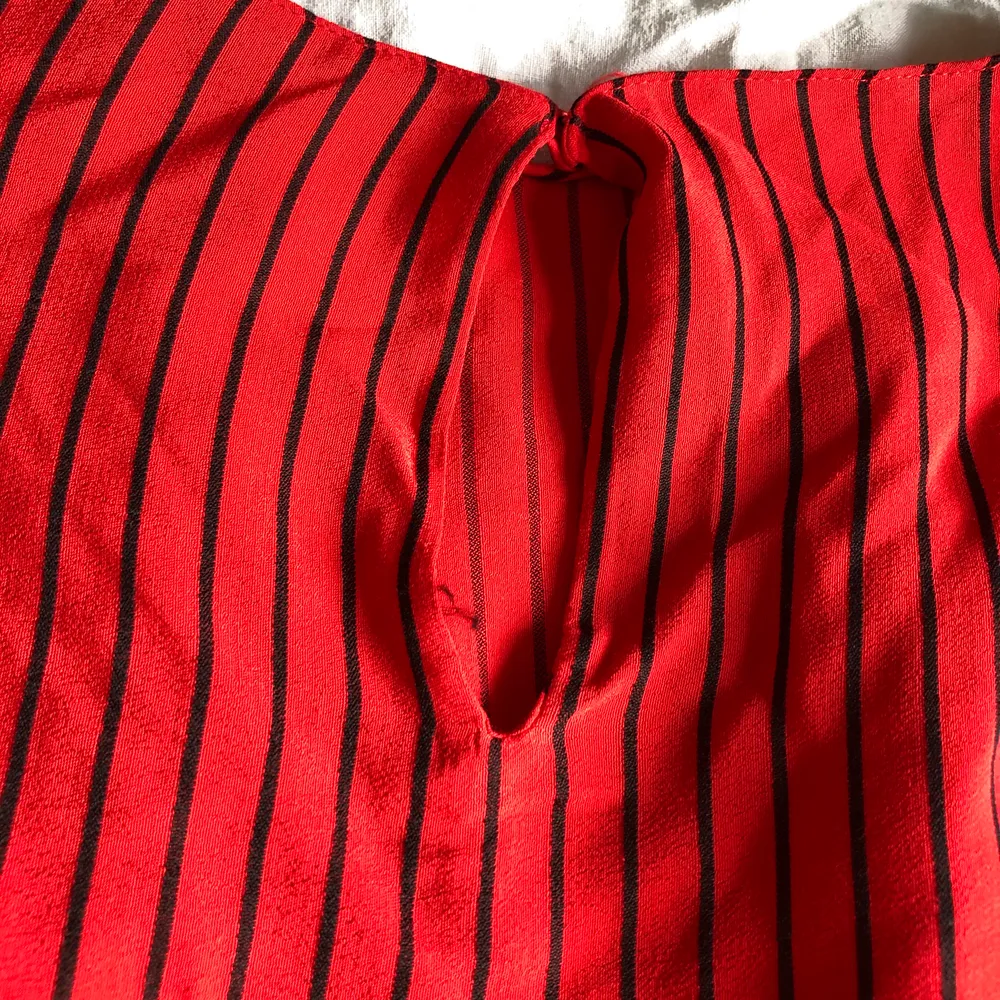 En supersöt röd blus från Zara med tunna svarta ränder. Använd väldigt fåtal gånger och är därmed i superbra skick. Köparen står för frakten!. Blusar.
