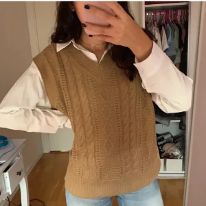 Stickad väst - Jättefin trendig stickad väst i besh/ljus brunt. Mönstrad där framme och slät där bak och enkel vringning. Tycker verkligen om en sånhär outfit men känner bara inte att det är min stil, så den är aldrig använd och därför säljer jag den💞 Frakt tillkommer!