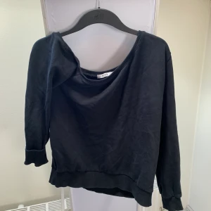 Svart one shoulder tröja - Svart tröja som endast täcker en axel. 
