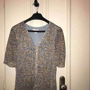  - Vacker lång klänning i mönster. Fint svall och halvlånga armar. Knappar hela vägen. Hm 34 men passar mig som annars har 36 