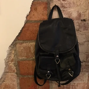  - Liten ryggsäck i svart fake-läder från HM, köptes 2016 och är som ny. 

Passar till vilken outfit som helst verkligen, och rymmer mer än man tror! 