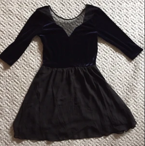  - Klänning i mörkblå sammet, mesh och skirt svart tyg. Aldrig använd. Tight passform upptill med urringning i ryggen. Kjolen är tunn och utställd, men med en underkjol. 

Jag är 166 cm och kjolen slutar ca 1 dm ovanför knät. 

Köparen betalar frakt, kan annars hämtas i Göteborg.  