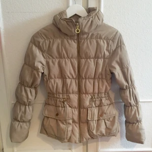  - Säljer en beige dunjacka från Zara! Dragkedjan är guldfärgad. Den kommer aldrig till användning pågrund av för liten storlek. 