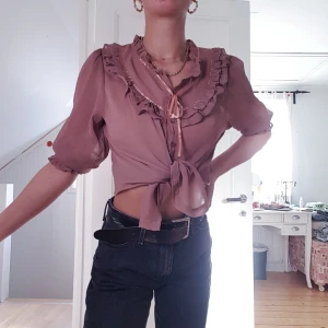 Blus med volanger - En jättefin blus med volanger och andra fina detaljer. Färgen är som på bilden (vet inte vad färgen heter). 💙 Storlek M men passar mig som har S.