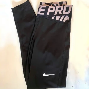 Nike pro träningstights - Jättesnygga tights från Nike, av modellen intertwist/crossover. Säljes pga tyvärr blivit för små för mig i midjan (är en storlek S). Sparsamt använda ca 8 gånger, köptes för ca 300kr och jag säljer för 70kr (kan diskuteras). Köparen står för frakt😇