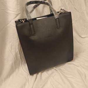 En svat fejk-läder väska från NA-KD. Den är aldrig använd all plast är kvar och även lappen.  200kr+frakt