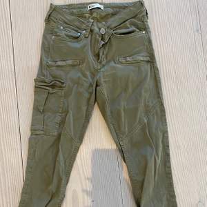 Gröna ”cargo” pants från Gina tricot med en tajt passform i stretchigt material, fint skick