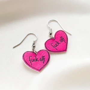 Örhängen - hjärtan med text - Handgjorda örhängen med motiv av hjärtan med texten ”fu*k off”. Rekommenderas att användas vid tillfällen då du är riktigt irriterad eller ska dumpa någon... 