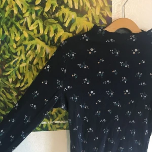  - Mörkblå halvpolo med superfint mönster. Storleken är L. På mig som har S/M i det mesta sitter den inte tight men är knappast för stor. Tyget är stretchigt! 