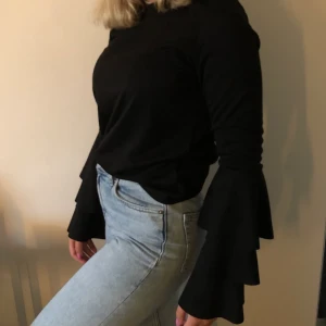 Svart tröja med volang armar från nakd - Nästan aldrig använd, väldigt bra skick