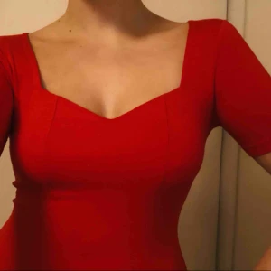  - Söt röd klänning med sweetheartringning. Använd endast en gång, så den är i mycket fint skick. Stretchigt och väldigt skönt material. Kan mötas upp i centrala Stockholm eller skicka mot fraktavgift.