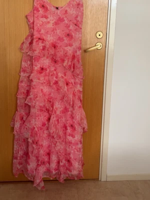 Blommig rosa långklänning Vero Moda - Säljer en  långklänning från Vero Moda i rosa toner med blommigt mönster. 