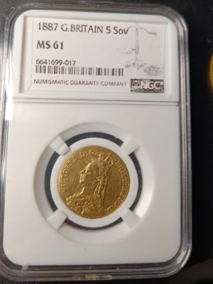 1887 Storbritannien 5 Sovereign guldmynt i NGC slab  - Säljer ett brittiskt 5 Sovereign guldmynt från 1887, inkapslat och graderat av NGC. Myntet har ett porträtt av drottning Victoria på ena sidan och Sankt Göran som besegrar draken på andra sidan. Perfekt för samlare av mynt och ädelmetaller. Myntet är i mässing eller koppar eller nåt liknande med guldplätering som jag har lagt i en NGC slab, serienumret funkar och streckkoden funkar också. Myntet har samma diameter och vikt som ett äkta 5 sovereign guldmynt och är väldigt sällsynt att hitta.