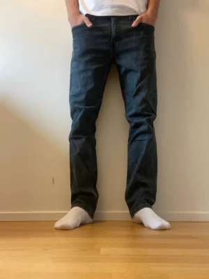 Levi's 511 mörkblå/svarta jeans herr - Säljer ett par mörkblå Levi's 511 jeans. Det är en slim modell som sitter lite lösare än vanliga slim jeans. Skickar är mycket bra förutom lite slitageveck runt om på jeansen. Nypris: 1199kr