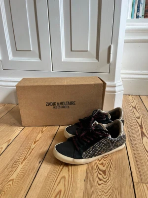 Zadig & Voltaire sneakers - Supersnygga skor från Zadig i storlek 37. Det finns lite tecken på användning (se bild) men de är väldigt sparsamt använda och i mycket bra skick. Kartong medföljer. Originalpris 370€.