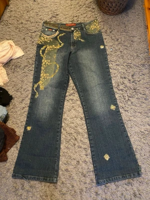 Snygga jeans byxor med cool design💚 - Super snygga jeans med cool design med spets, nitar och glittriga stenar💚längd: 102cm, innerbenslängd 77cm, midja: 40x2 cm, 