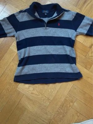 Polo half zip - Säljer en fin polo half zip i stormen 10-12 år vilket motsvarar ungefär xxs. Den passar mig som är 163. Inga defekter fint skick
