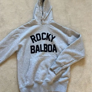 Zalando hoodie - Grå Rocky Balboa hoodie från zalando med tryck på ryggen, lite nopprig💛